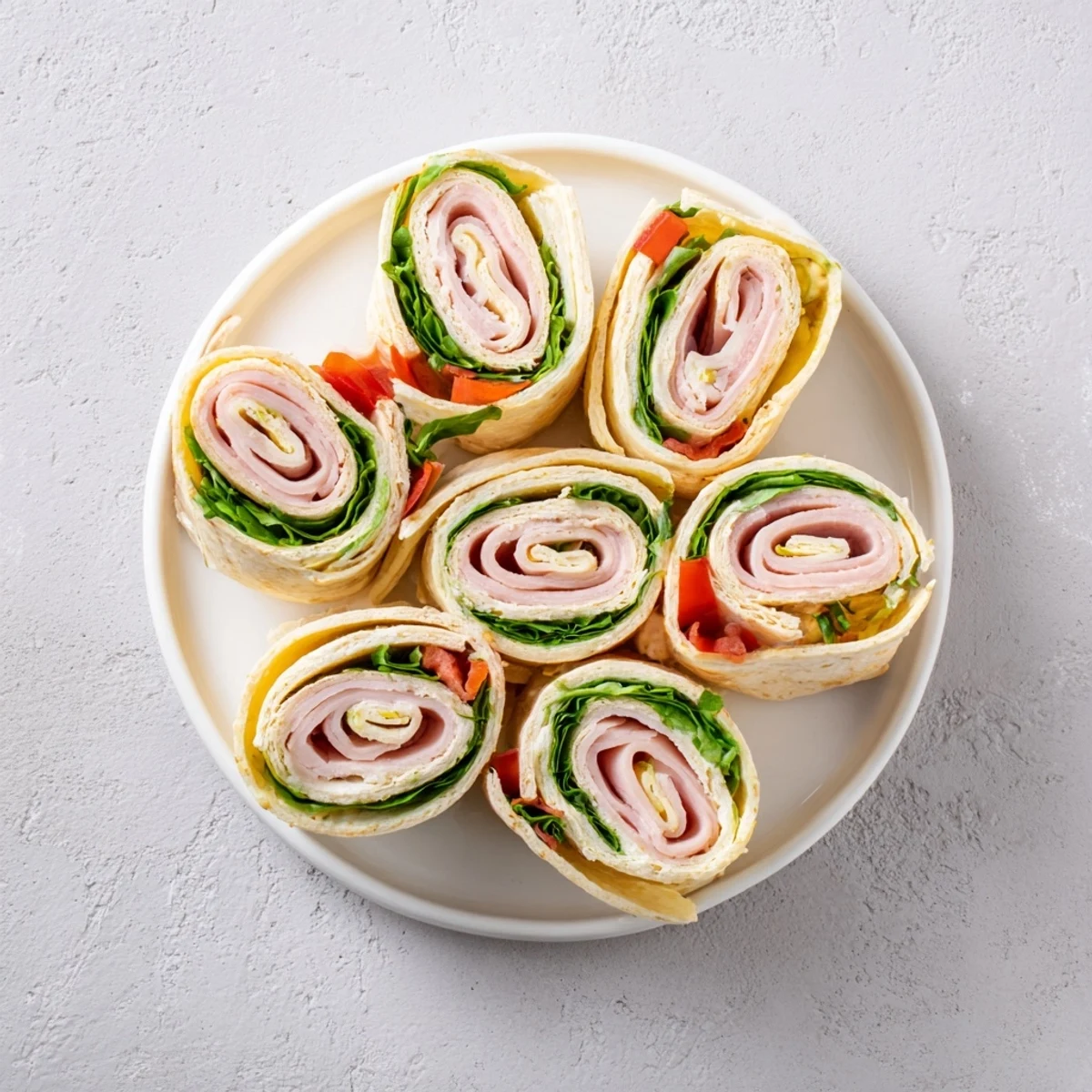 Turkey and Provolone Pinwheels: A close-up shows tender turkey and cheese spirals ready to enjoy.