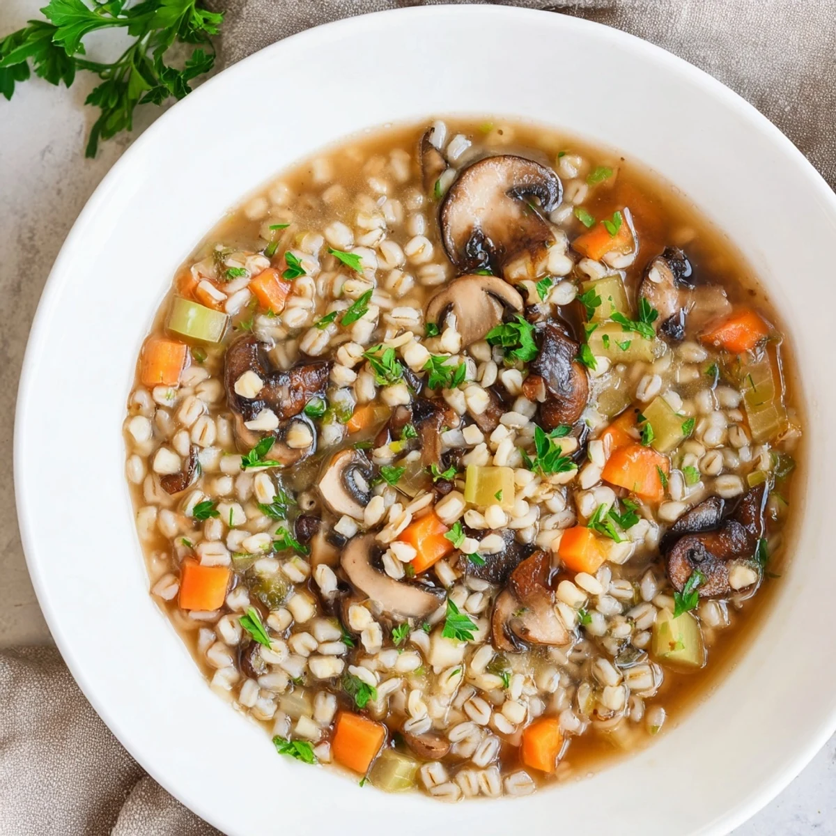 Close-up of a bubbling pot of Wild Mushroom and Barley Soup, featuring vibrant mushrooms and thick barley.
