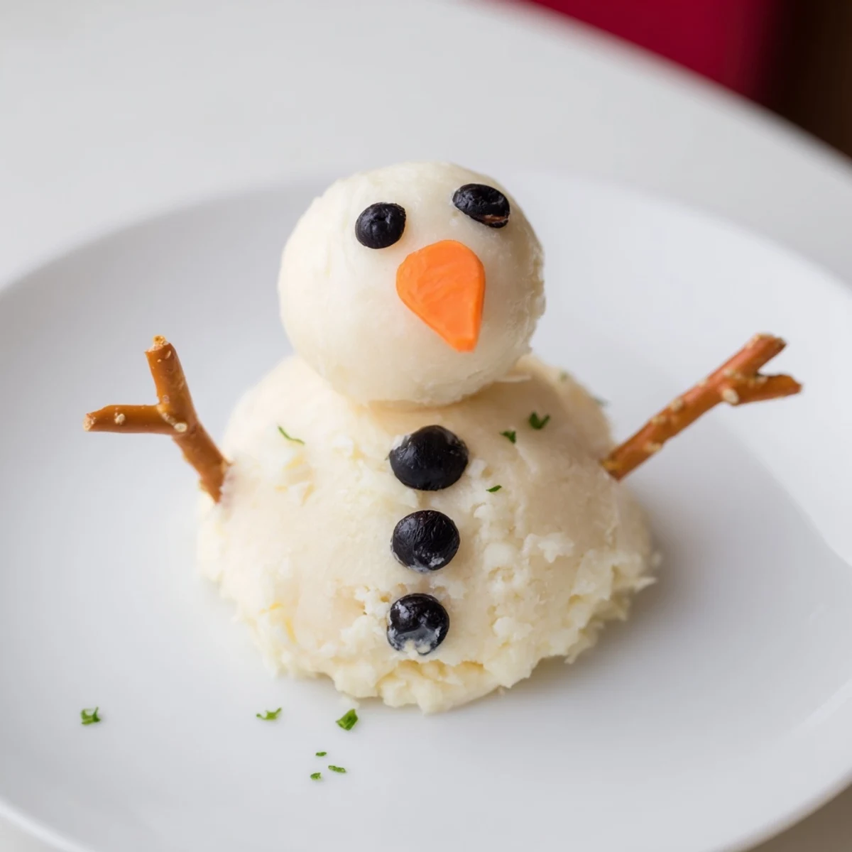 Creamy melted snowman cheese bites, featuring pretzel arms and carrot noses, ready to serve with crackers.
