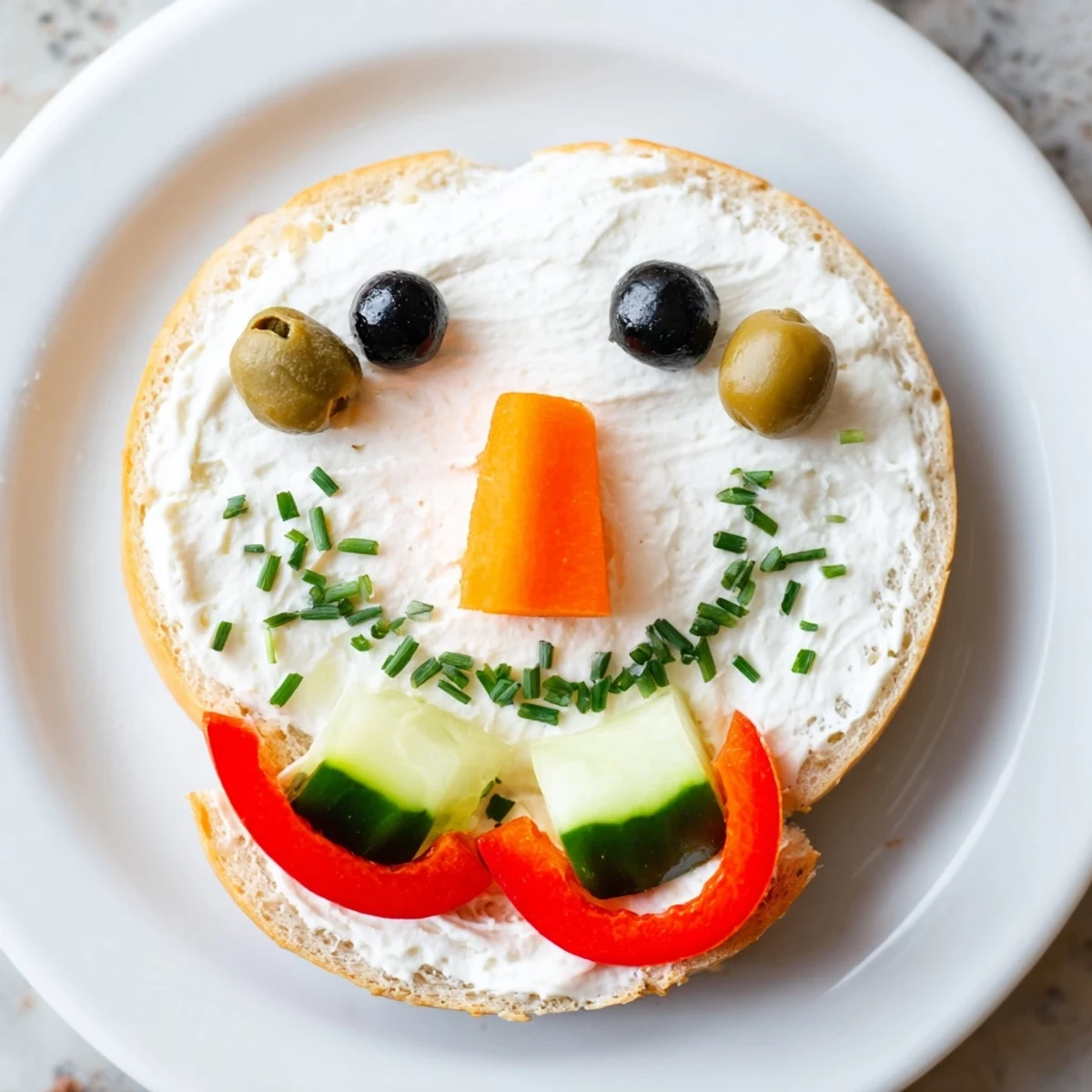 Snowman Mini Bagel Sandwiches featuring happy faces and carrot noses, perfect for a festive lunch!