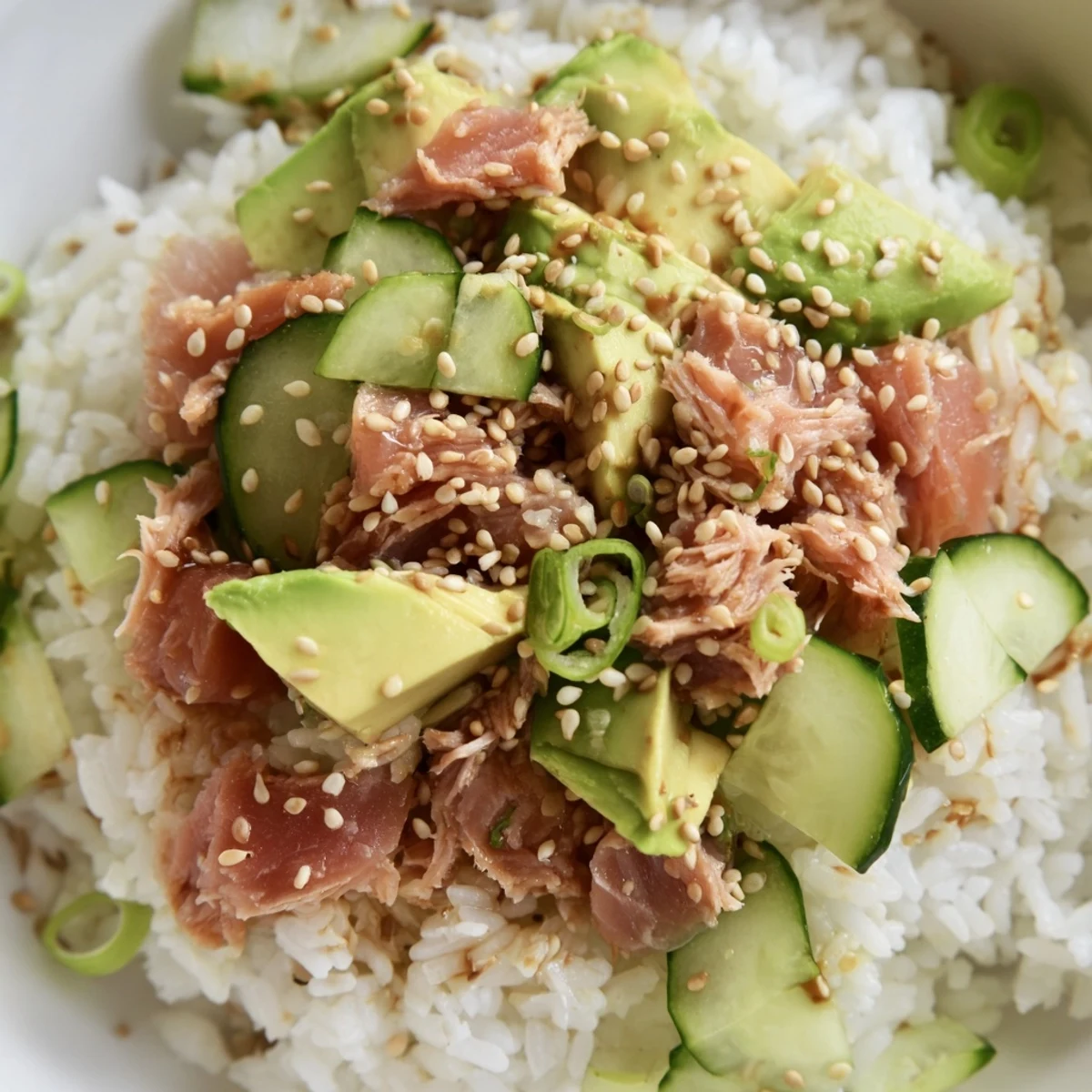 Enjoy a nutritious fusion dinner with this colorful Tuna Avocado Rice Bowl, combining tender tuna chunks, ripe avocado, and crunchy veggies over fragrant fluffy jasmine rice.