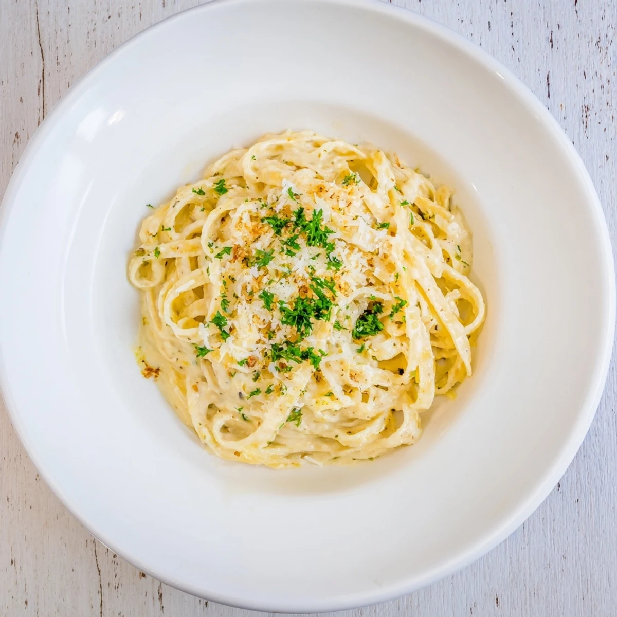 Hearty fettuccine tossed in a velvety roasted cauliflower Alfredo sauce, served steaming hot with a golden-brown roasted garlic garnish.