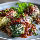 A close-up of Cabbage Rolls shows golden edges, ground meat and rice filling, and fresh parsley garnish.
