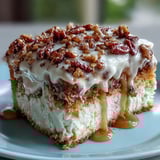 Slice of moist Butter Pecan Tres Leches Cake revealing soaked layers and rich cream topping.