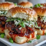 A close-up view shows juicy ground turkey filling topped with fresh slaw on toasted buns, ready to eat. 