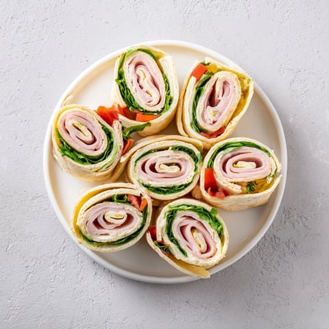 Turkey and Provolone Pinwheels: A close-up shows tender turkey and cheese spirals ready to enjoy.