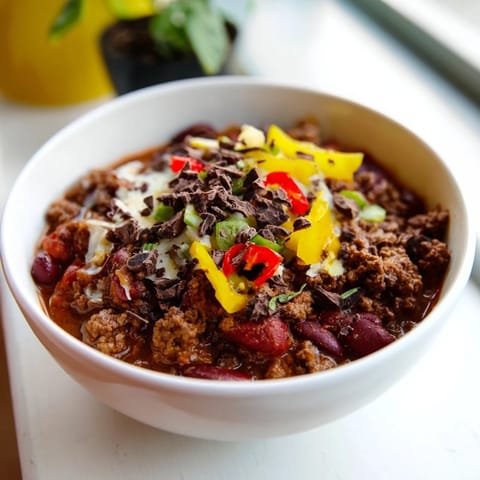 A close-up of hearty One-Pot Cozy Chocolate Chili topped with fresh cilantro garnish.