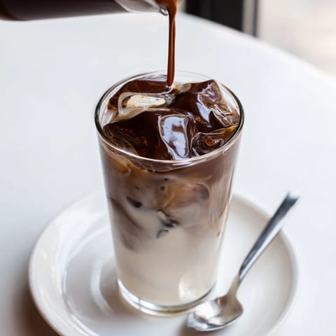 The irresistible Chocolate Cracking Iced Latte, featuring a creamy, cold coffee drink with a rich chocolate crust.