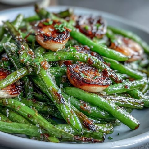 Roasted garlic green beans with caramelized garlic and lemon zest, a savory and bright Easter side dish.