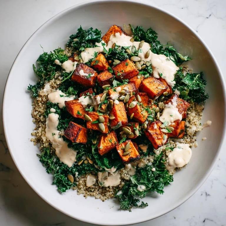 Flavorful light coastal bowl: imagine fluffy quinoa, tender sweet potatoes, and kale—perfect vegetarian meal.