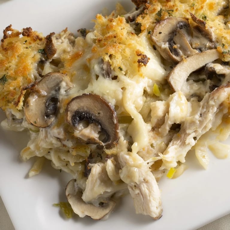 A bubbly, cheesy Turkey Tetrazzini casserole, filled with mushrooms and savory turkey in a white wine sauce.