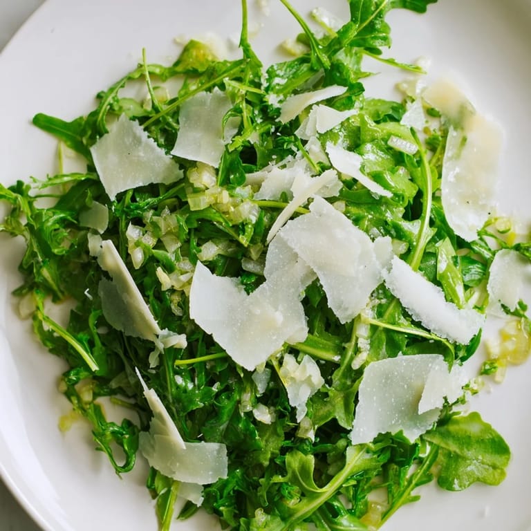 Close-up of a vibrant Arugula salad drizzled with delicious lemon vinaigrette.