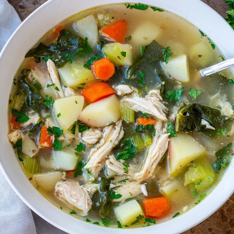 A ladle of hearty Collard Greens, Chicken and Vegetable Soup with tender potatoes, carrots, and vibrant greens.