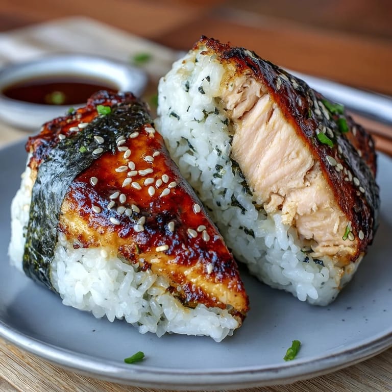 Golden-brown onigiri with grilled salmon filling, offering a perfect blend of smoky flavor and soft, sticky rice.