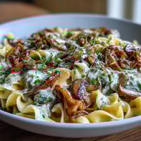 A creamy vegetarian stroganoff with sautéed onions and mushrooms served over tender egg noodles.  