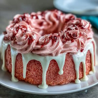 Elegant rosé velvet cake with a shimmering gold drip, perfect for showers.